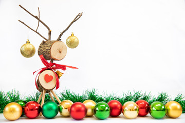 Fototapeta premium Wooden reindeer Christmas toy on isolated white background with tinsel and decorations 