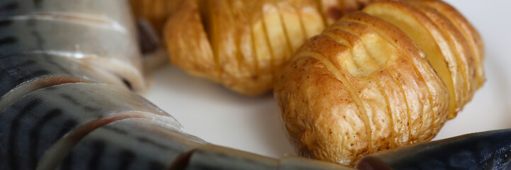 Baked golden potatoes with herring mackerel
