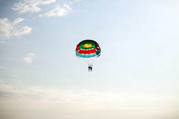 paragliding in the sky over the blue sea