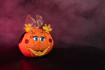 a painted pumpkin on a black background, the concept of Halloween