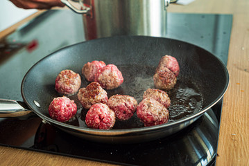  chef making meatballs on the kitchen