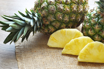 slices of pineapple on burlap  served on table top