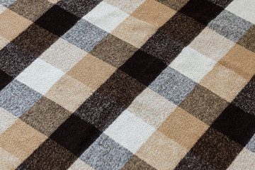 Fototapeta premium Brown checkered wool plaid fabric texture. tartan texture