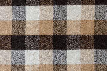 Brown checkered wool plaid fabric texture. tartan texture