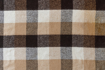 Brown checkered wool plaid fabric texture. tartan texture