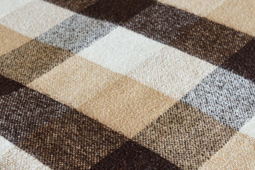 Brown checkered wool plaid fabric texture. tartan texture