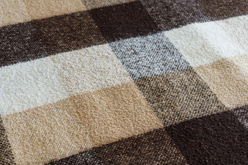 Brown checkered wool plaid fabric texture. tartan texture