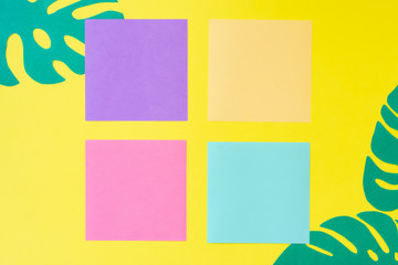 Creative layout made of monstera leaves and four colorful square framess with copy space