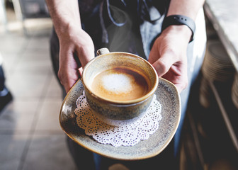 A person holding a coffee