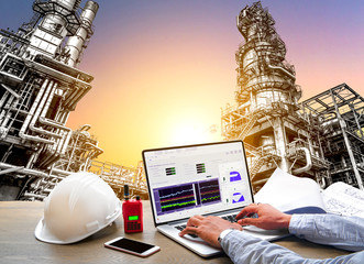Double exposure Engineering Industrial concept in office with Oil and gas Industry refinery zone,equipment of Pipelines and petrochemical plant background