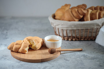 Tasty breakfast, croissants with honey. french breakfast concept, close-up. Space for text.