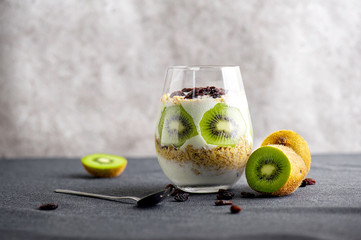 Yogurt granola parfait with mango,kiwi, tropical fruits and chia seeds, layered dessert or breakfast. Selective focus
