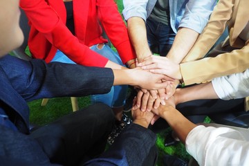 Group of people sharing and putting their hands together in the meeting for successful work and business unity Stack of hands for encouraging and motivating each other in psychotherapy
