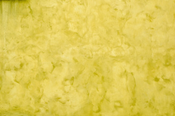 Old wall of a building covered in yellow paint