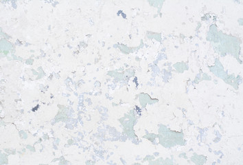 Light blue old concrete wall with partially peeling paint