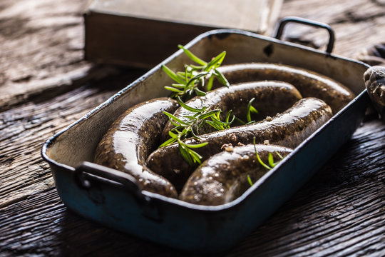 Roasted sausages in pan with rosemary. Traditional european food bratwurst jaternice or jitrnice