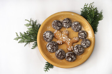 Beautiful round gingerbread man-shaped cookies on a plate in sweet icing. Winter Christmas and New Year theme background