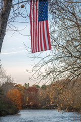 US Flag Flutters over West Canada Creek during Sunset at Barveveld, New York