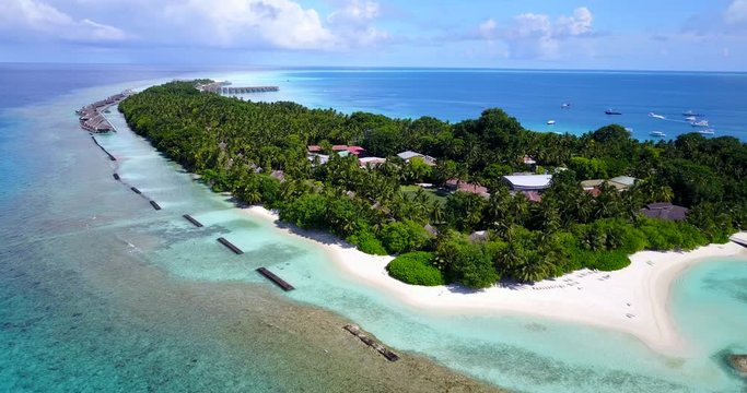 Glorious Island Resort Surrounded by  White Sandy Beach, Palm Trees, and Turquoise Ocean in Canda - Aerial Shot