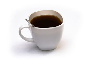 White cup of coffee with a spoon on an isolated background. Black cappuccino drink in a bowl