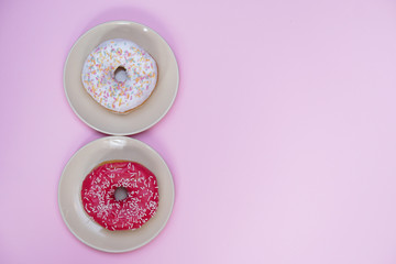 Fototapeta na wymiar Beautiful juicy donut with a sweet cream..Cupcake on a pink background for kitchen design.