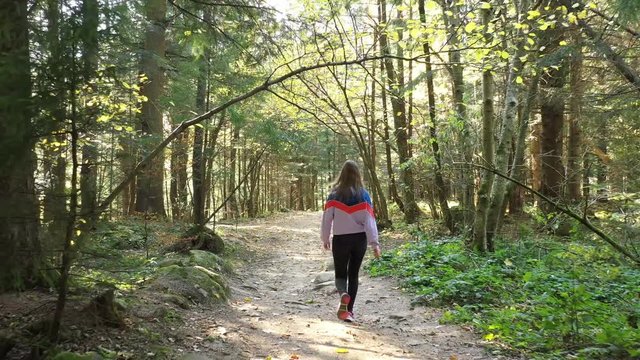 Girl walking in the autumn Carpathian forest