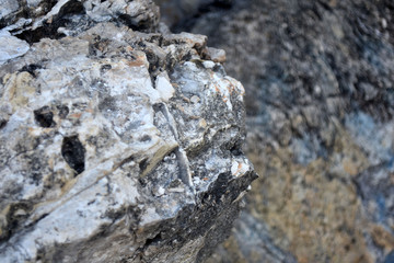 Beautiful texture of the light stone is photographed in close-up. Details of rock nature texture. A rocky ground surface.