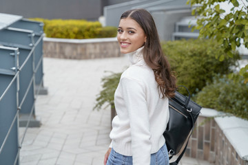 Cheerful woman getting to her work on foot