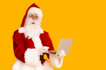 Astonished Santa Claus chatting with children through the Internet