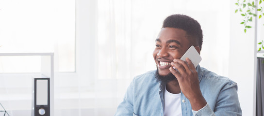 Successful black businessman talking on phone in office