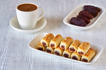  Dates stuffed cookies with cup of turkish coffee . Close up    
