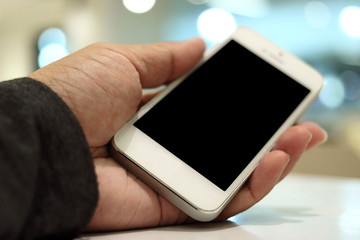 Mobile smart phone on hands of man. Selective focus and shallow of field.