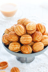 Cookies Nuts with condensed milk in a metal vase, selective focus