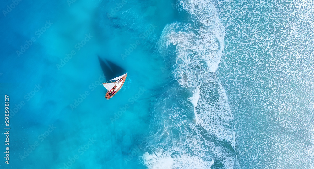 Wall mural wave and boat on the beach as a background. .beach and waves from top view. turquoise water backgrou