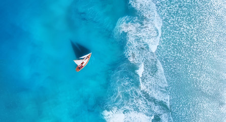 Wave and boat on the beach as a background. .Beach and waves from top view. Turquoise water background from top view. Top view from drone. Travel - image