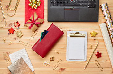 Laptop, credit cards, purse and christmas decoration. Online christmas shopping, buying gifts