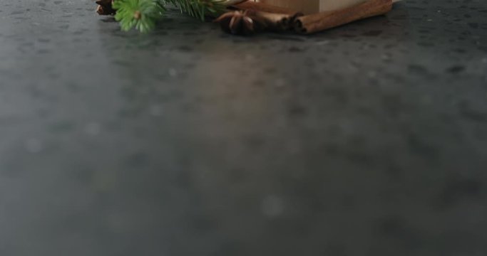 Tilt shot of brown gift box with natural decorationson terrazzo countertop