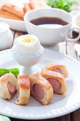 Breakfast with sausages in a yeast dough, selective focus