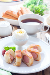 Breakfast with sausages in a yeast dough, selective focus