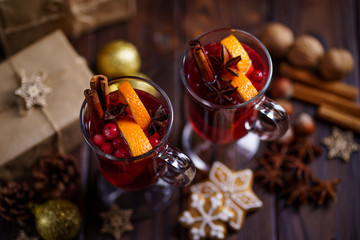 Christmas holidays atmosphere, cold winter day. Warming mood. Mulled wine with cranberry, cinnamon, orange and anise.