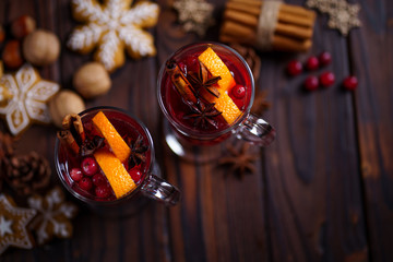 Christmas mulled spiced wine with cranberry and oranges. Traditional hot winter drink, festive beverage with Xmas or New Year decorations