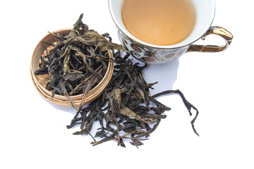 Cup of tea with dry tea leaves