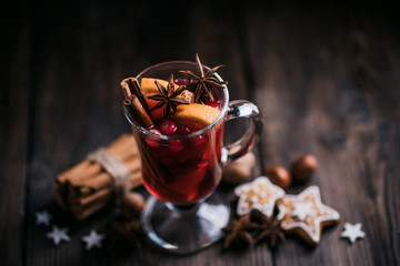 Christmas and New Year cozy holiday composition with hot mulled wine, traditional festive sweets and nuts . Winter holidays celebration concept