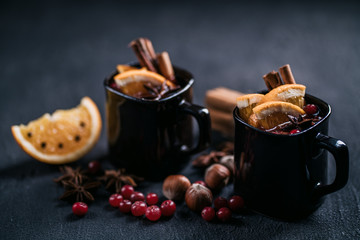 Christmas magic atmosphere, home celebration. Hot mulled wine, spices and festive natural decorations. Winter holidays celebration concept