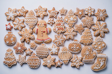 Festive food, kitchen background, texture with homemade gingerbread cookies on white table. Christmas and New Year celebration traditions