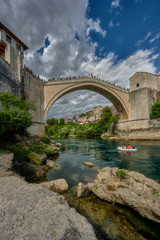 Obraz premium Old Bridge - a stone suspension bridge over the Neretva River in the city of Mostar in Bosnia and Herzegovina