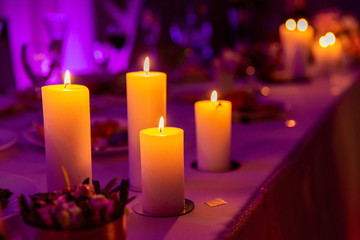 Burning candle on colorful bacground