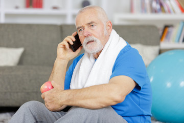 elderly man on the phone after working out - Powered by Adobe