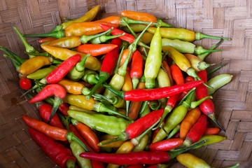 Fresh chilies in a container made of bamboo.