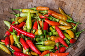 Fresh chilies in a container made of bamboo.